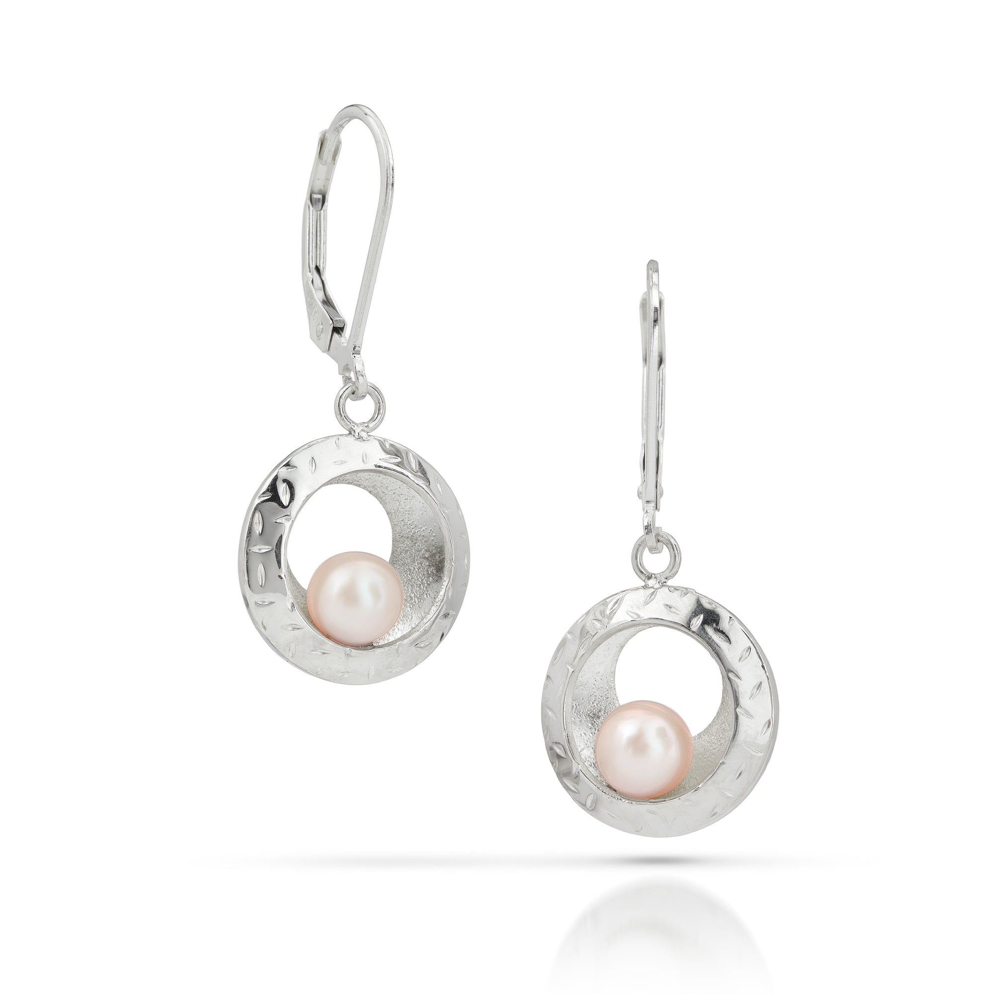 Silver dangle earrings with pink pearls balancing on silver disc on a white background