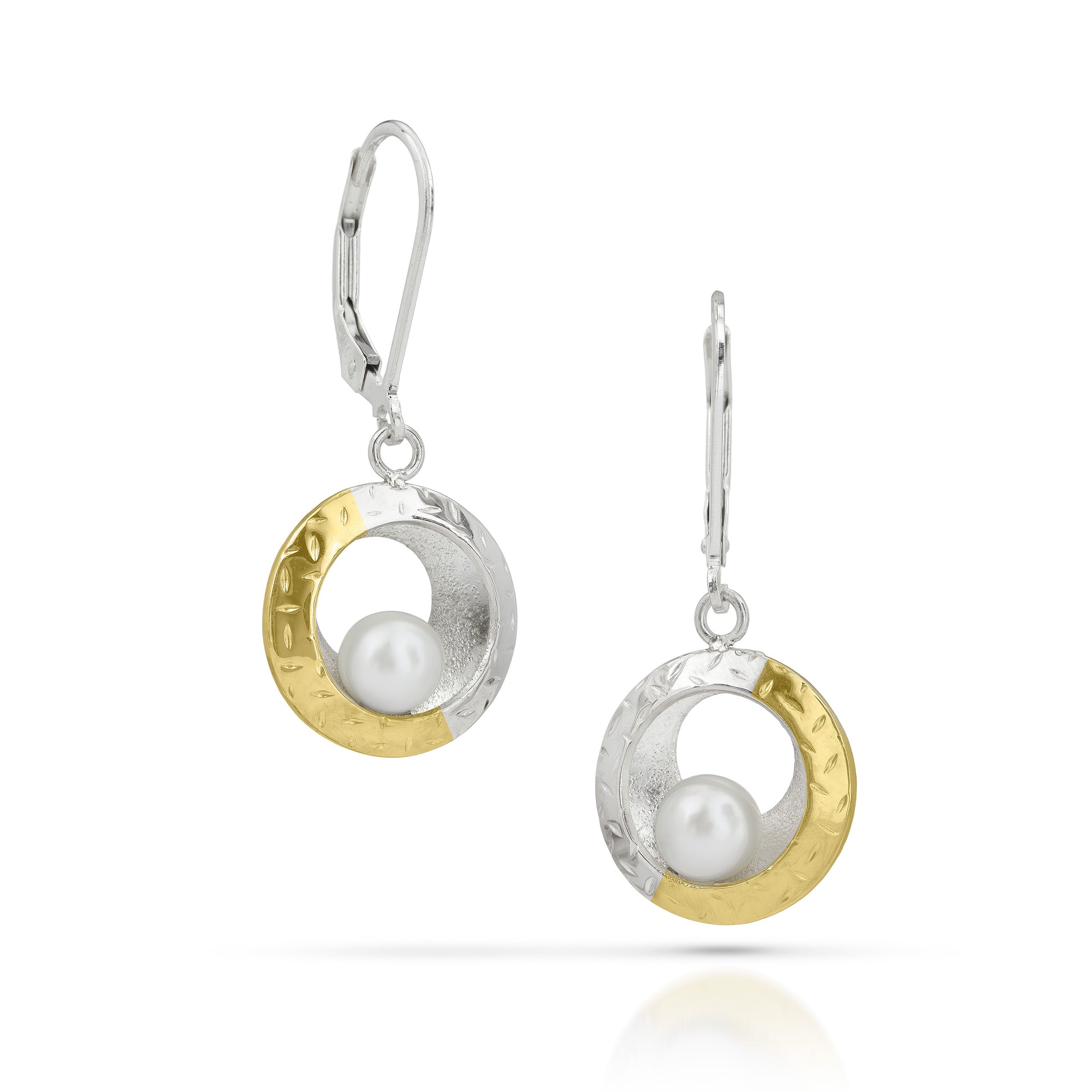 Pair of earrings with gold and silver circular designs featuring pearls on a white background