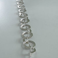 Connecting in Circles silver bracelet laid out straight-Kelli Jewelry