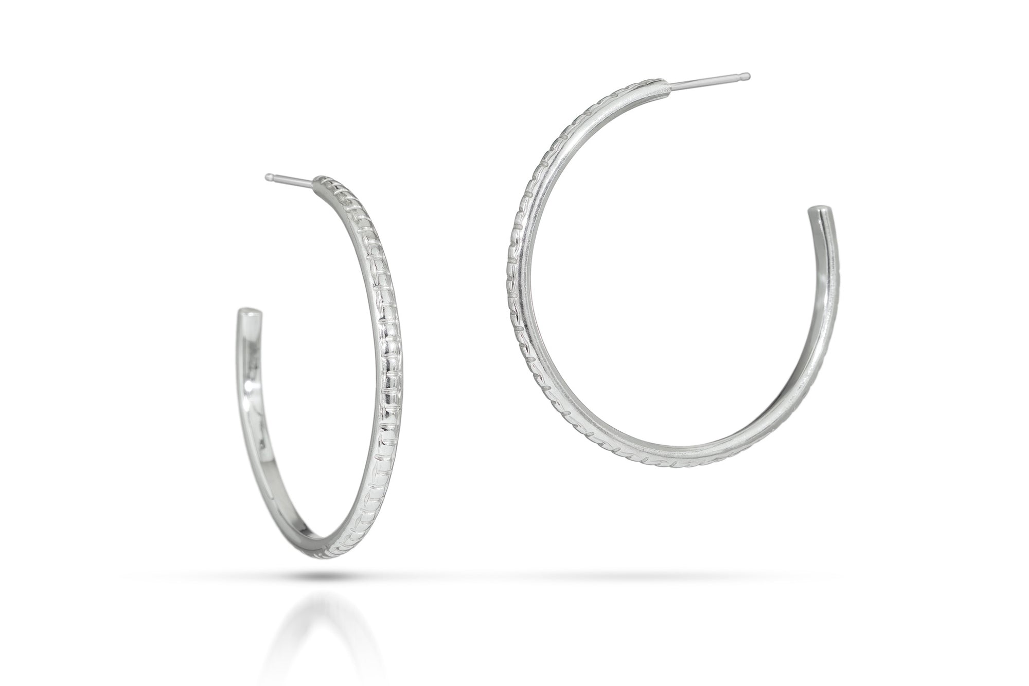 Pair of silver hoop earrings on a white background