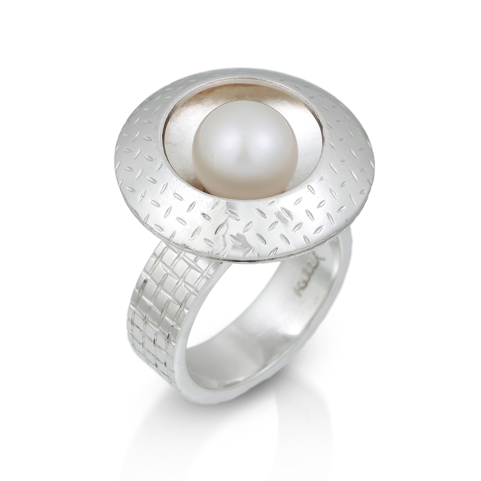 Silver ring with a central pearl  in the center on a white background