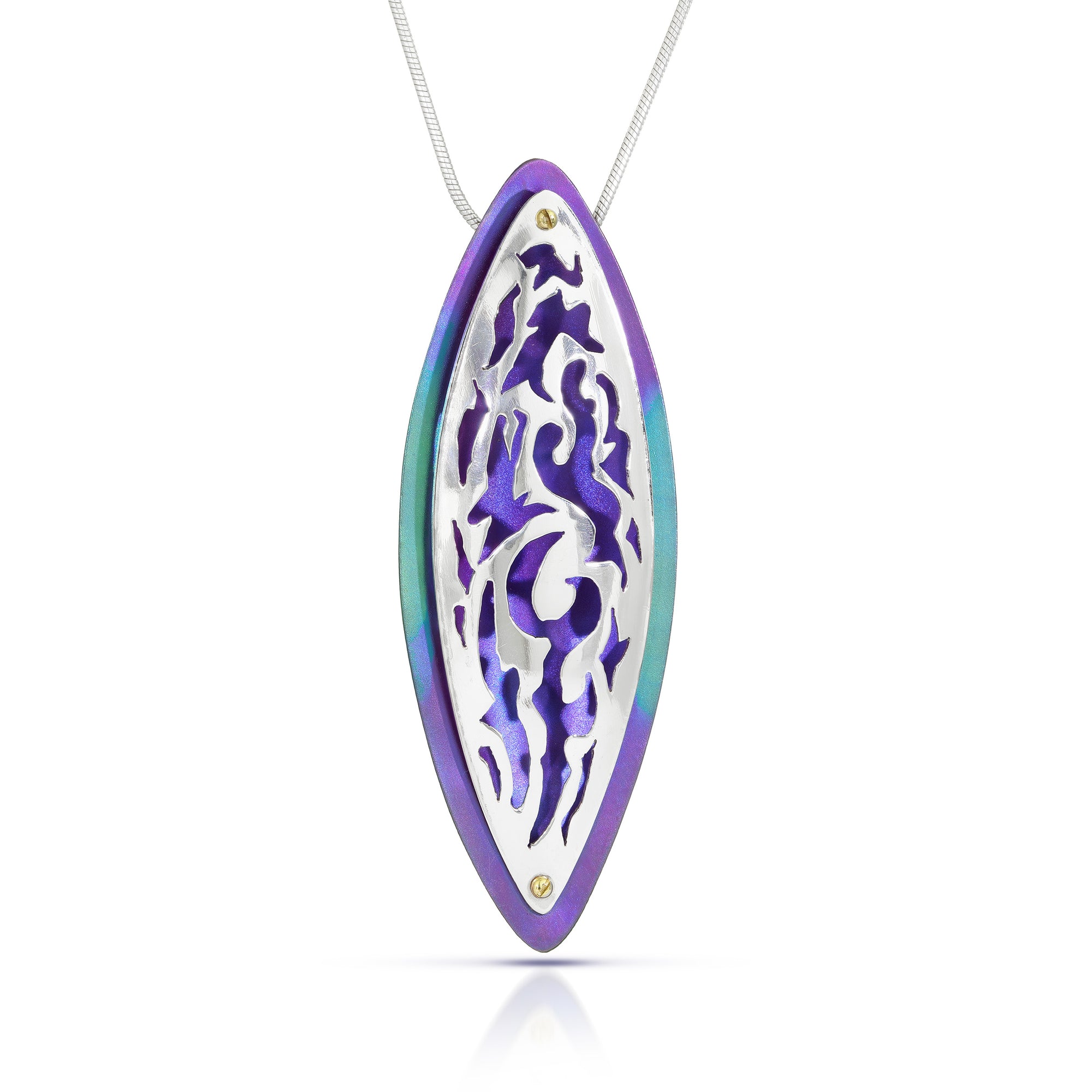 Silver pendant with cut-outs that show a background of the titanium piece of purple and green on a white background