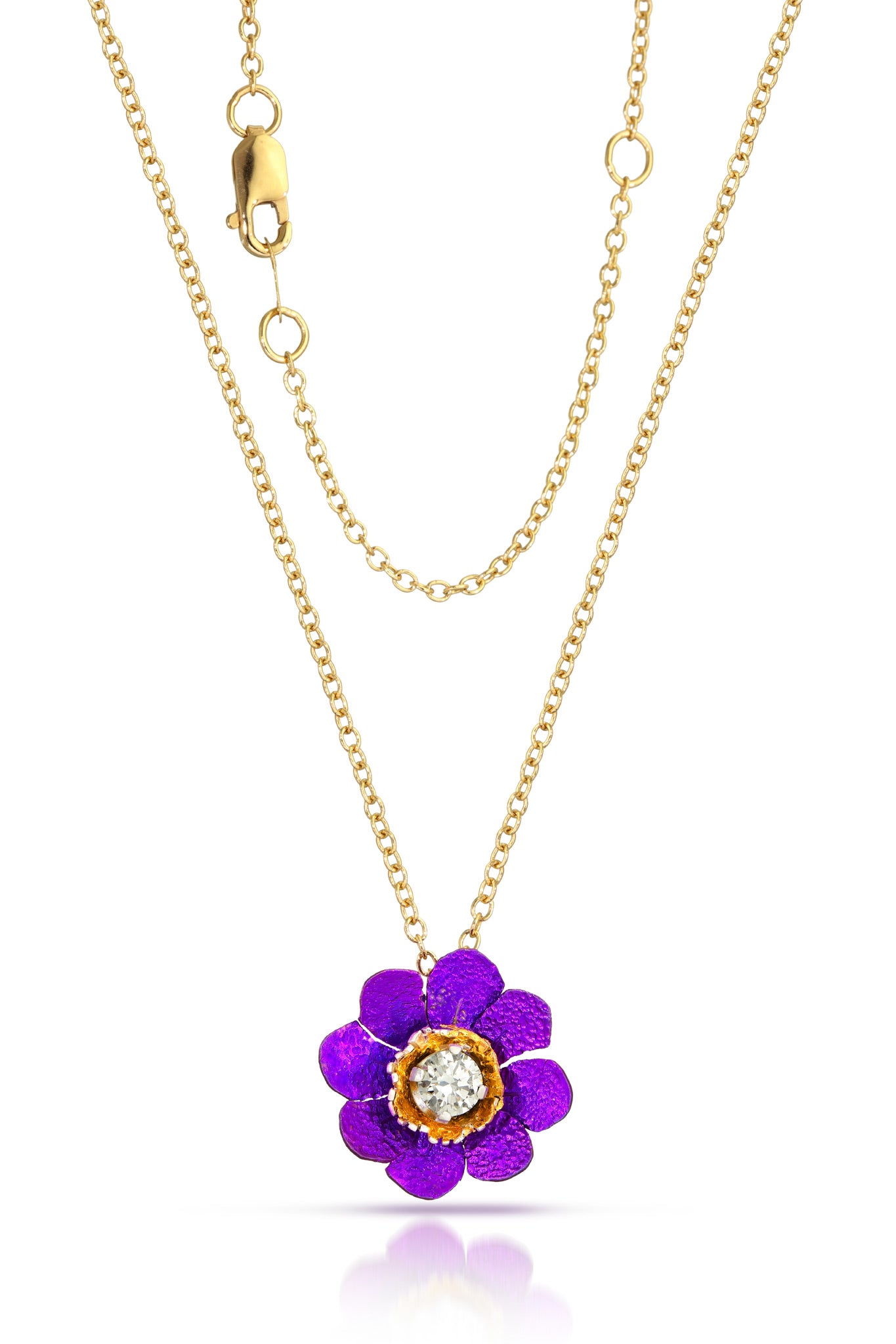 Gold necklace with a purple flower pendant on a white background