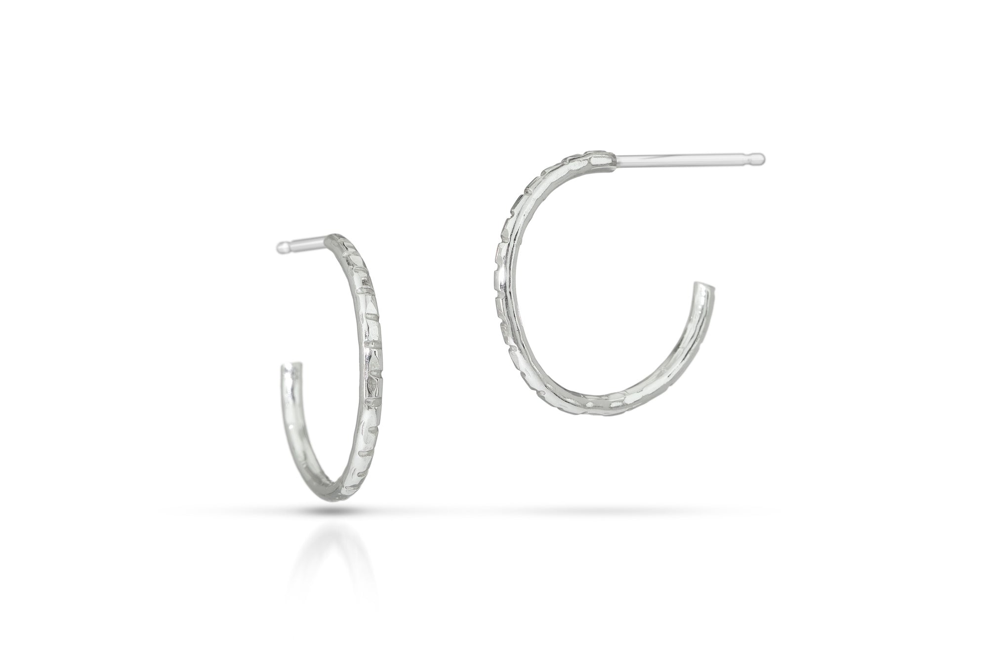 Silver hoop earrings on a white background
