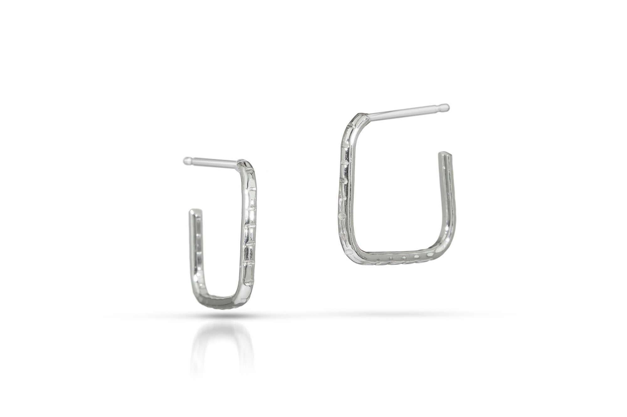 Pair of silver square hoop earrings on a white background